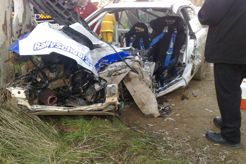 A crashed white rally car.