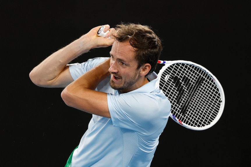 A man plays a shot during a tennis match