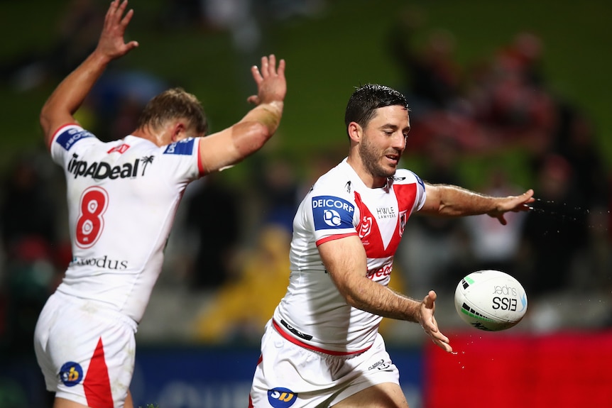 A man celebrates after scoring a try in a rugby league match