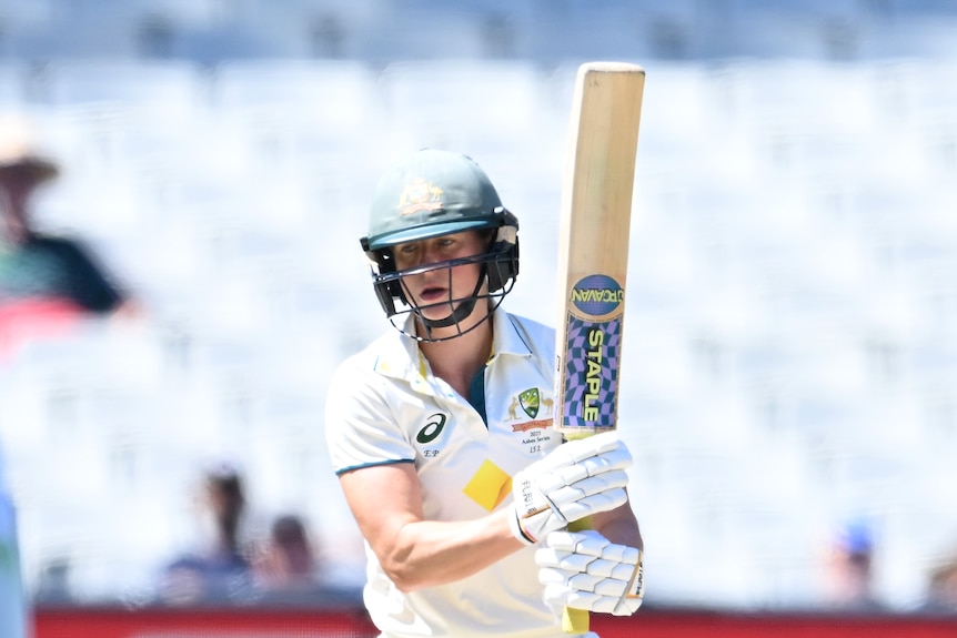 Ellyse Perry holds her bat