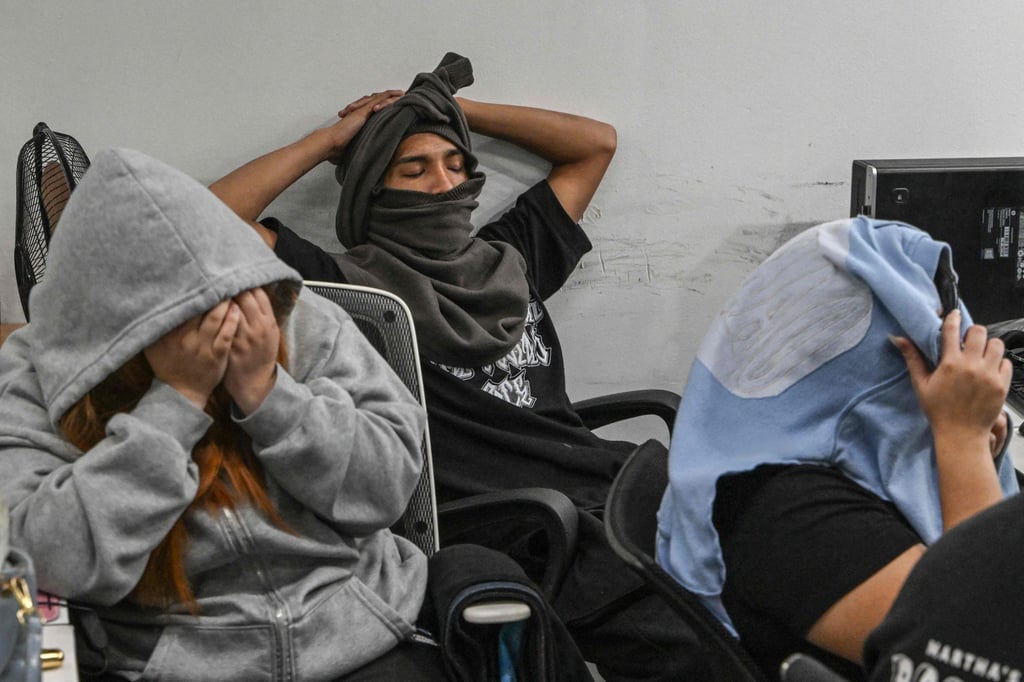 Workers during a raid by agents of the Presidential Anti-Organised Crime Commission (PAOCC) and the National Bureau of Investigation at an office of a suspected online scam farm in Manila on January 31. Photo: AFP Workers during a raid by agents of the Presidential Anti-Organised Crime Commission (PAOCC) and the National Bureau of Investigation at an office of a suspected online scam farm in Manila on January 31. Photo: AFP