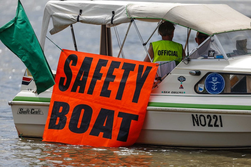 A boat with a sign saying "safety boat".