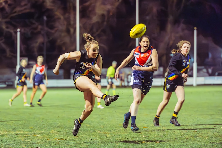a photo of women's footballers playing footy 