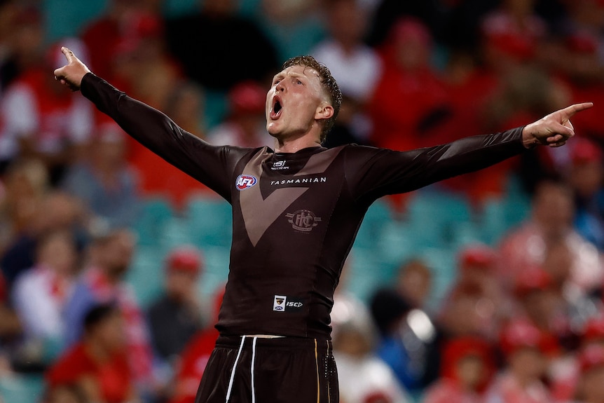 James Sicily celebrates a goal with his arms outstretched