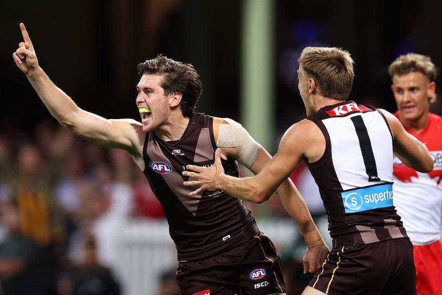 Will Day celebrates a goal with his right arm raised