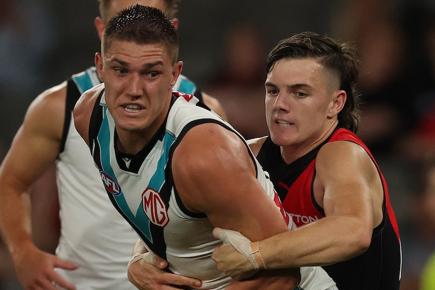 Jordon Sweet of the Power is challenged by Archie Roberts of the Bombers.