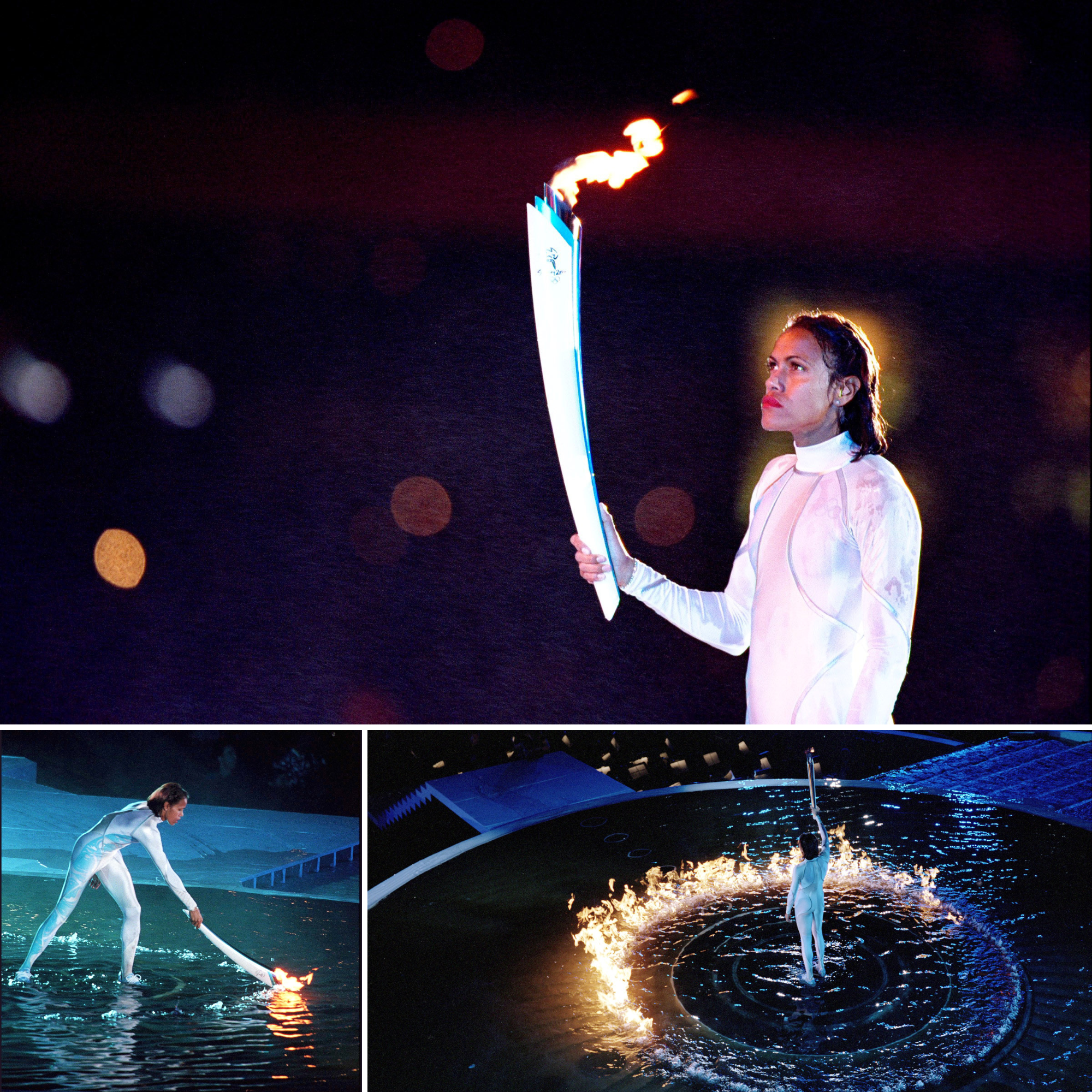 Cathy Freeman bends over and lights a pool of water with the Olympic torch. It ignites in a circle around her