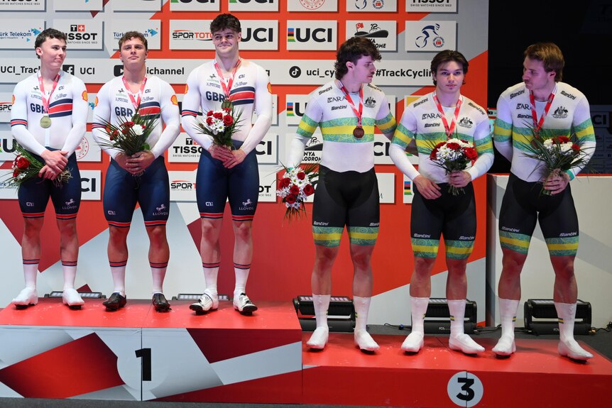Britain's team sprint squad stand on the top step with Australia third