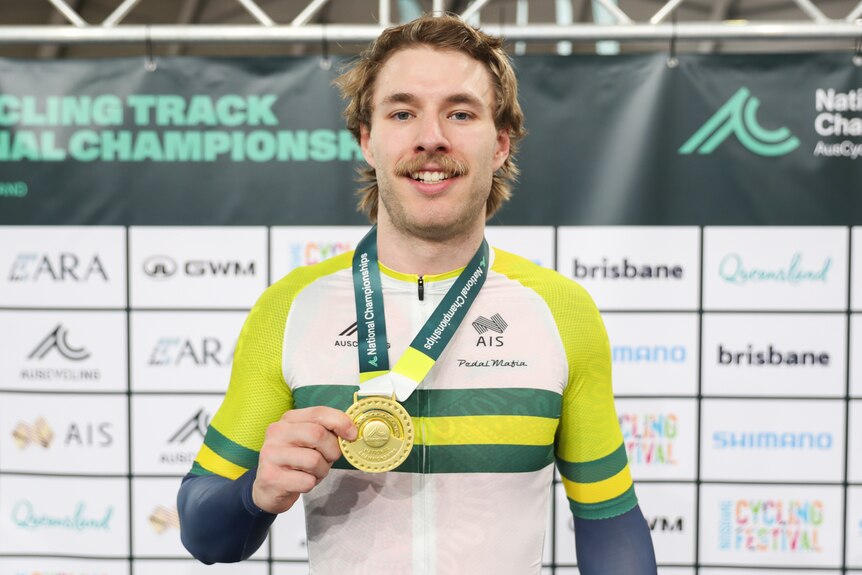 Leigh Hoffman holds a medal