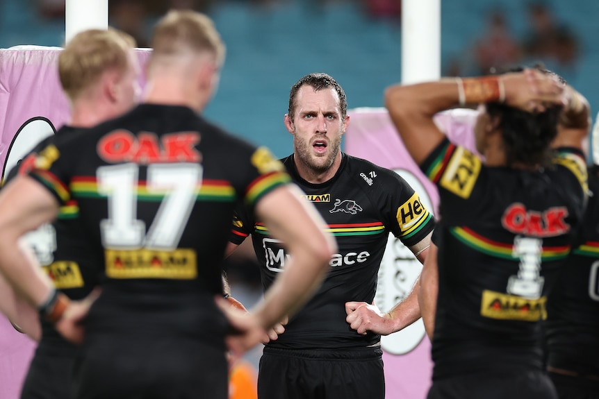 Isaah Yeo puts his hands on his hips as he and the Penrith Panthers stand under the posts after conceding a try in an NRL game.