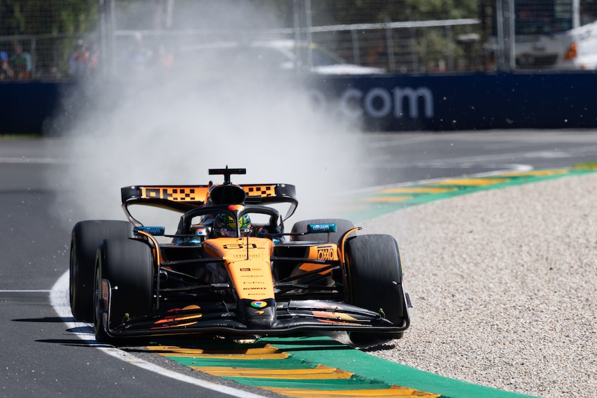 Oscar Piastri driving for McLaren Formula 1 over gravel