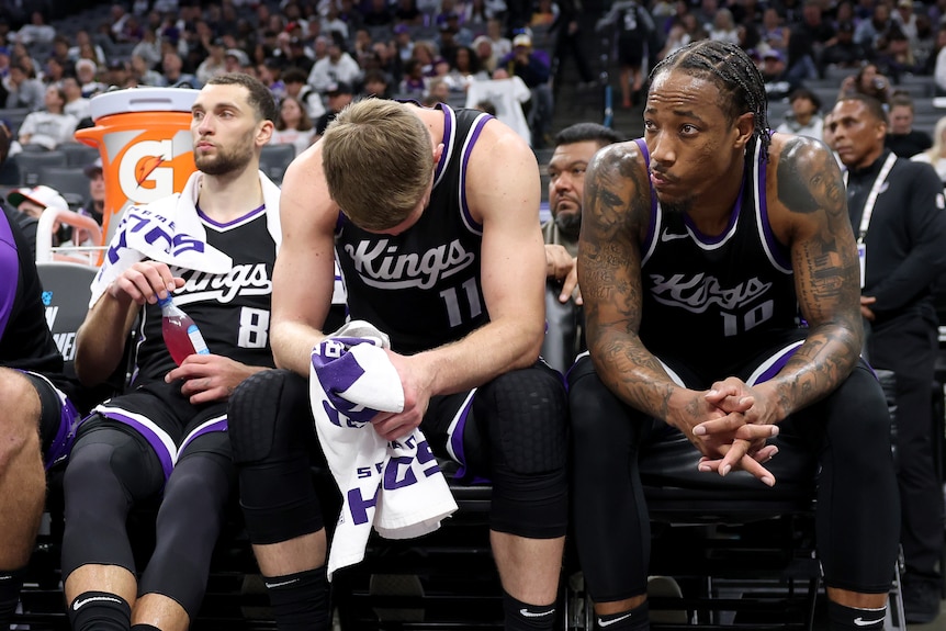 Zach LaVine, Domantas Sabonis and DeMar DeRozan on the bench