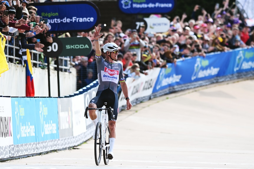 Mathieu van der Poel holds up three fingers