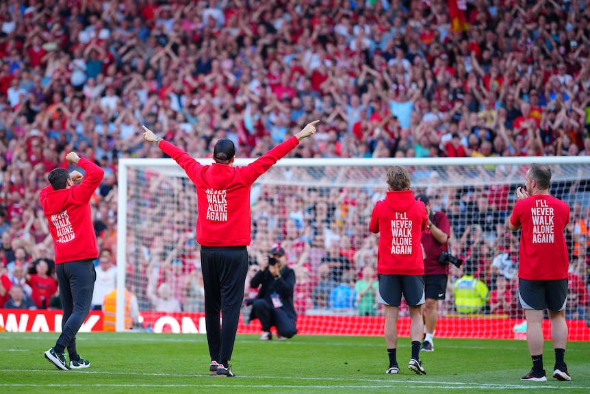 Jurgen Klopp holds up his hands in front of the Kop