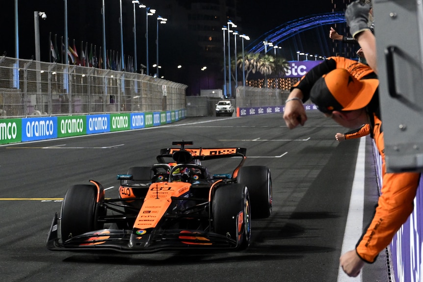 Oscar Piastri drives his McLaren past his support team after the Saudi Arabian Grand Prix in Jeddah.