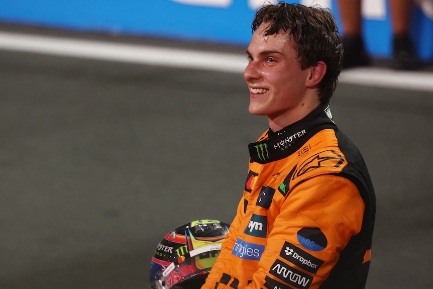 A man in an orange racing suit 