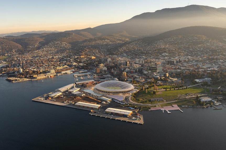 An aerial view of Hobart with a render of the proposed stadium at Macquarie Point