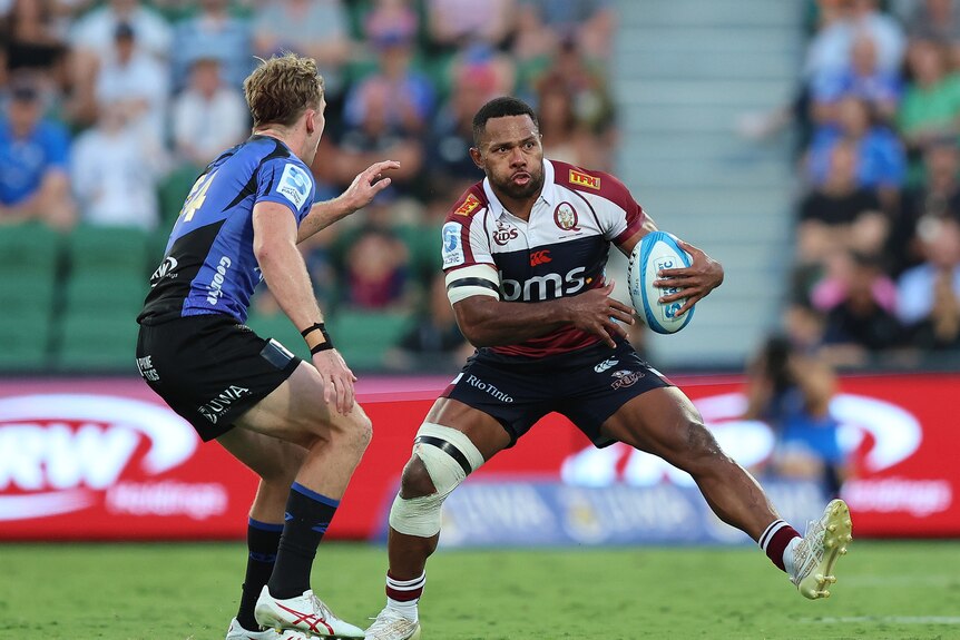 Filipo Daugunu holds the ball as he takes on the Western Force defence.