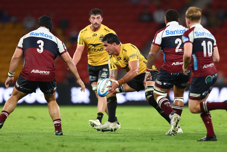 Darcy Swain holds the ball for the Western Force as he runs at the Reds' defence.