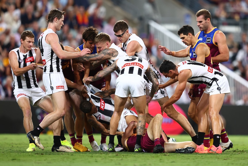 Collingwood and Brisbane players engage in a melee