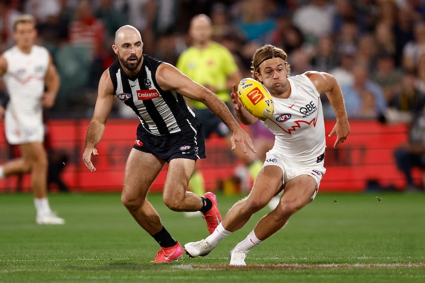 James Rowbottom gets to the ball ahead of Steele Sidebottom