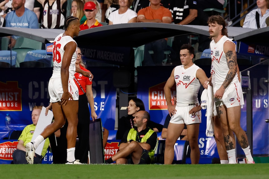 Joel Amartey walks to the Sydney bench while holding his hamstring