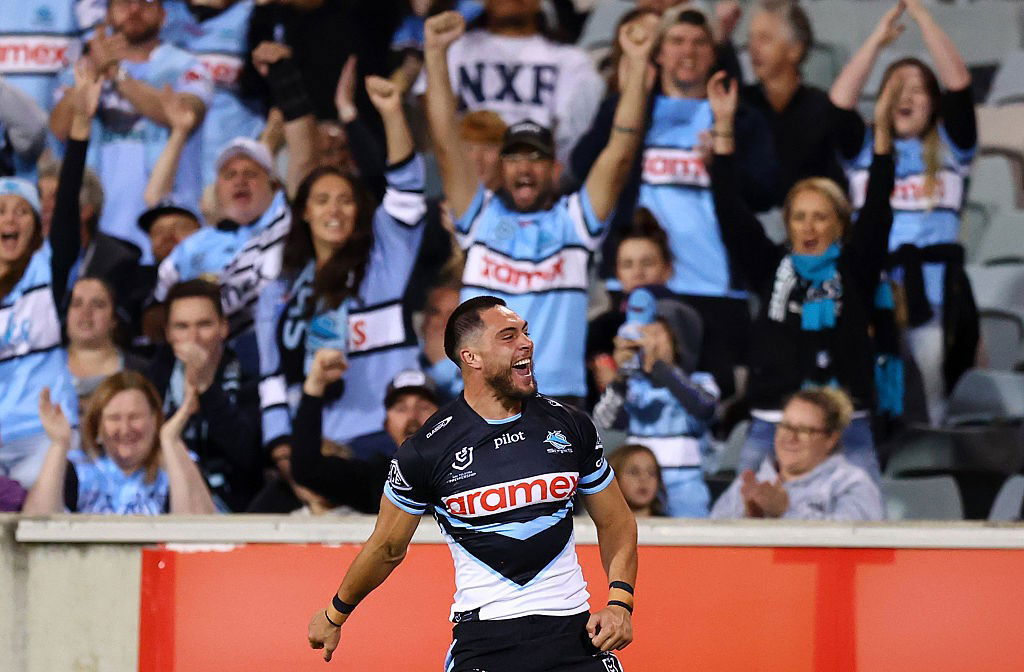 Mawene Hiroti celebrates a try in front of Cronulla Sharks fans.