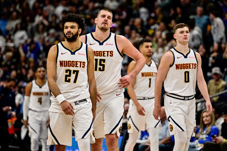 Jamal Murray, Nikola Jokic and Christian Braun walk off