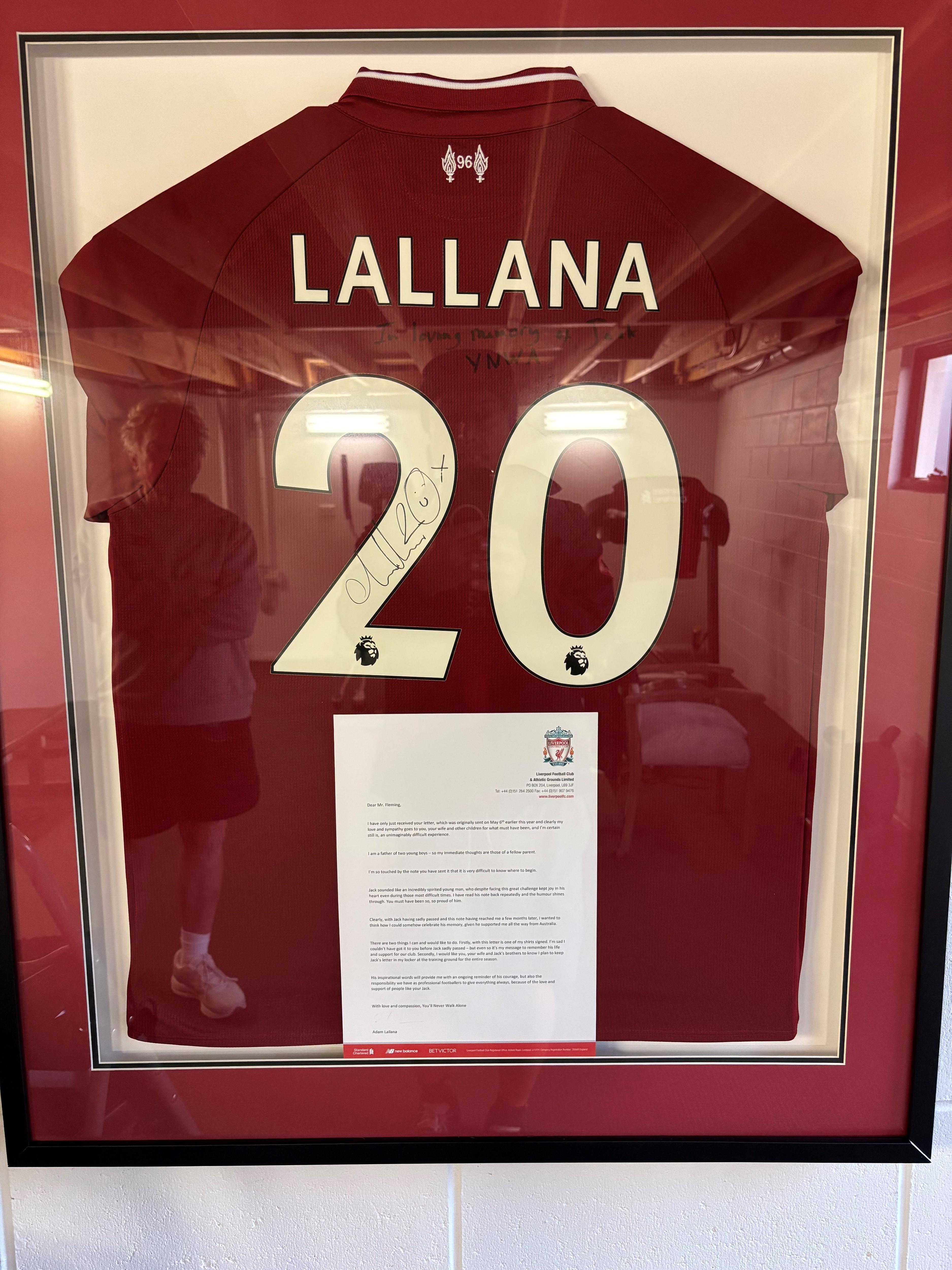 A red player's top with the words Lallana and the number 20, framed along with a letter.
