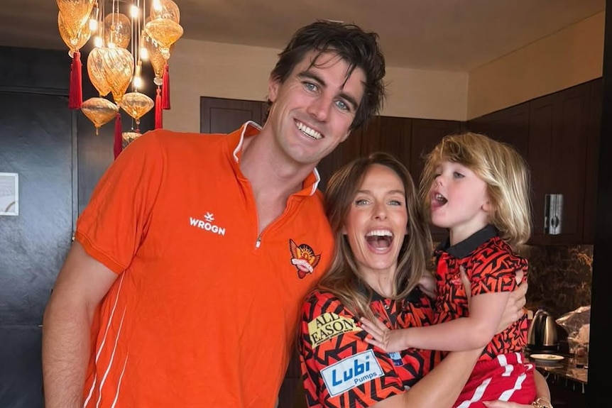 Pat and Becky Cummins with son Albie in Sunrisers Hyderabad IPL gear.