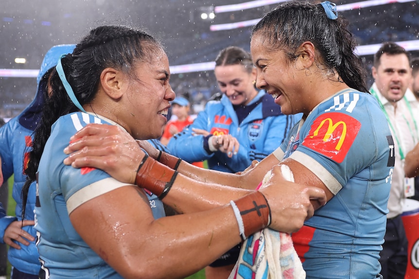 Tiana Penitani Gray and Sarah Togatuki celebrate the Blues' victory.