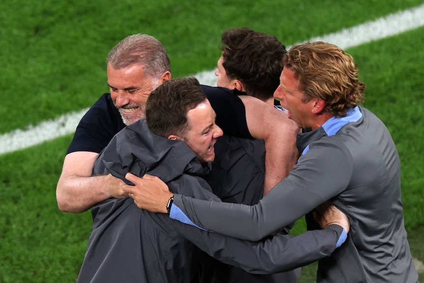 Ange is hugged by his team