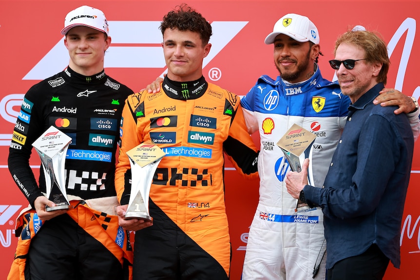 Oscar Piastri, Lando Norris and Lewis Hamilton on the podium after the Miami GP sprint.