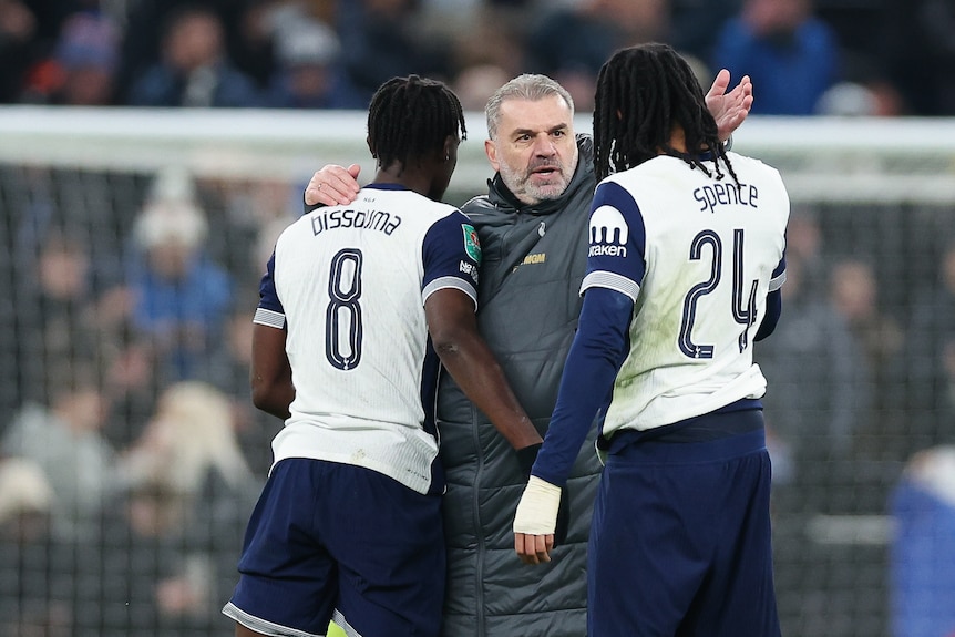 Ange Postecoglou hugs his players