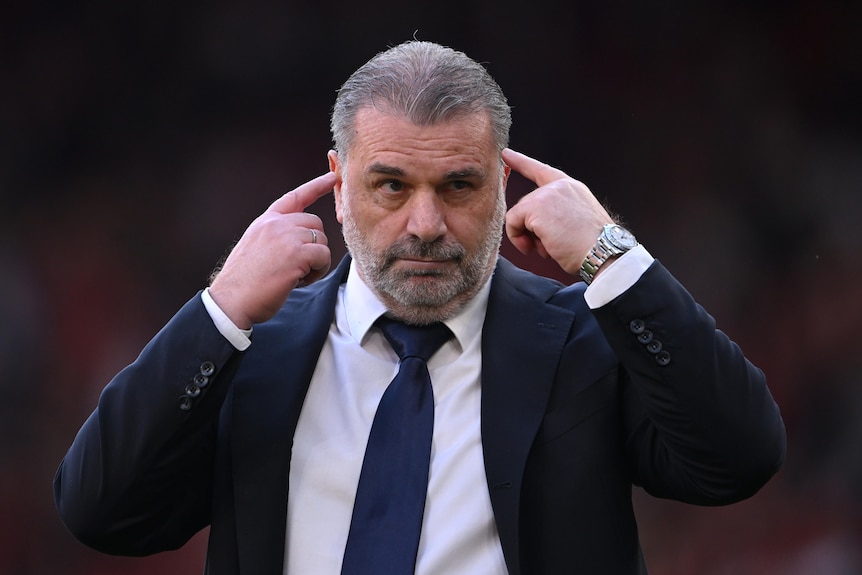 Ange Postecoglou points to his head