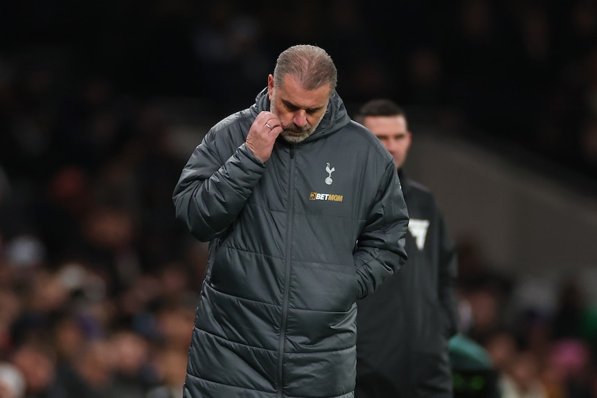 Ange Postecoglou scratches his face