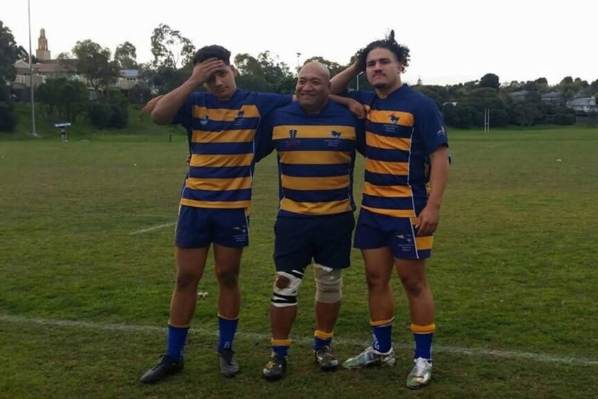 Sione Tuipulotu, Mosese Tuipulotu and Fohe Tuipulotu arm-in-arm, smiling for a picture after a rugby match