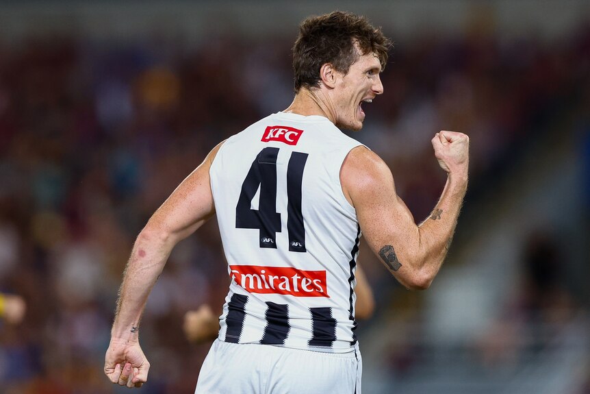 Brody, wearing a "41" white and black sleeveless jersey, shouts in celebration while raising a clenched fist.