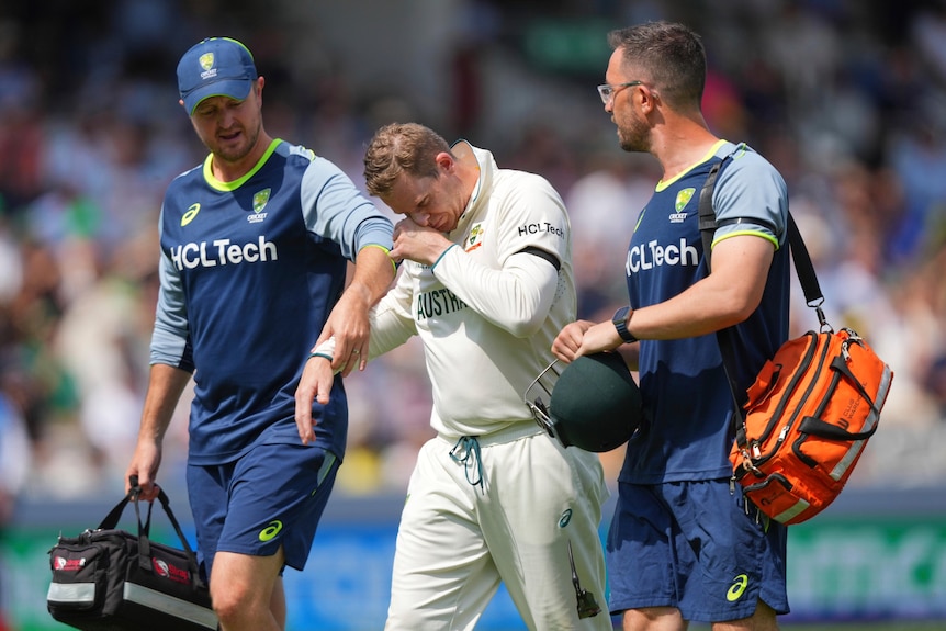 Australia's Steve Smith reacts in pain as he leaves the field