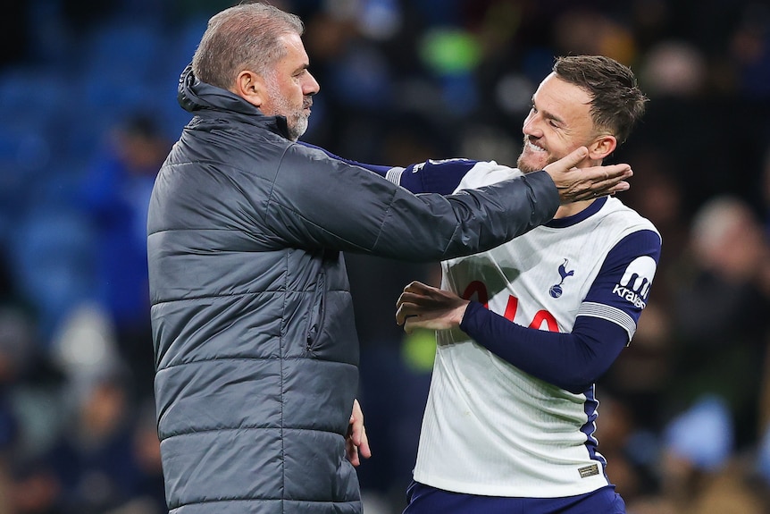 Ange Postecoglou embraces James Maddison as they celebrate during a Premier League match.