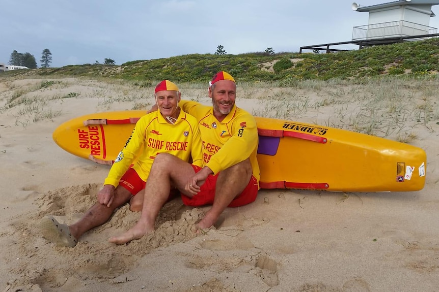 Two lifeguards sitting on a beach