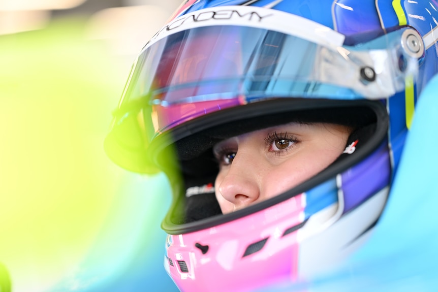 Joanne Ciconte with the visor on her helmet lifted, looking into the distance