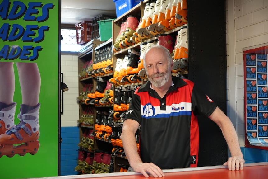 Ozzy Kilgallon stands behind roller skate hire counter at Morley Rollerdrome.