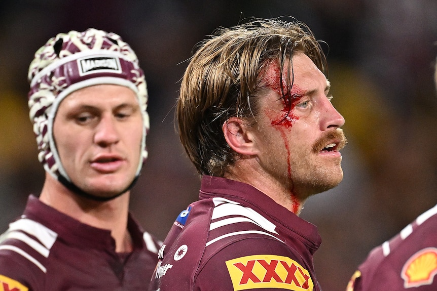 Kalyn Ponga stands alongside Cameron Munster