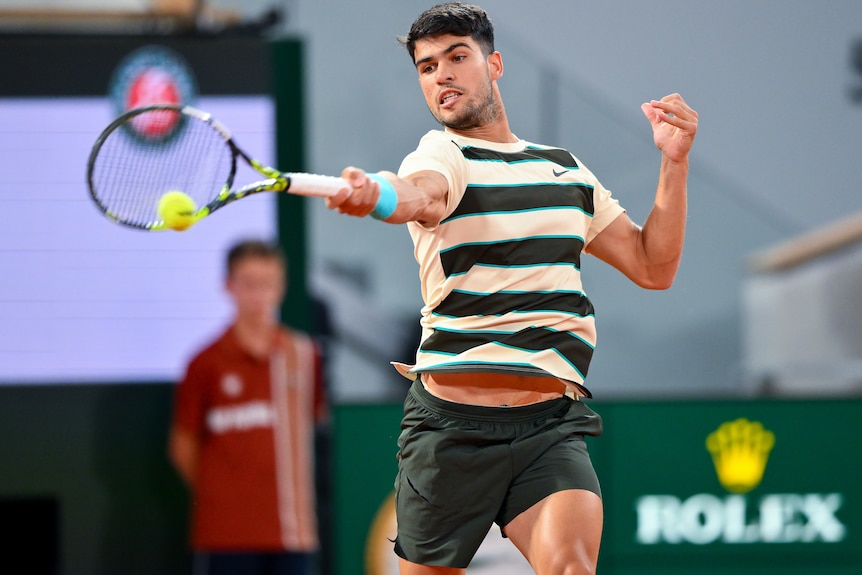 Carlos Alcaraz plays a forehand at the French Open.