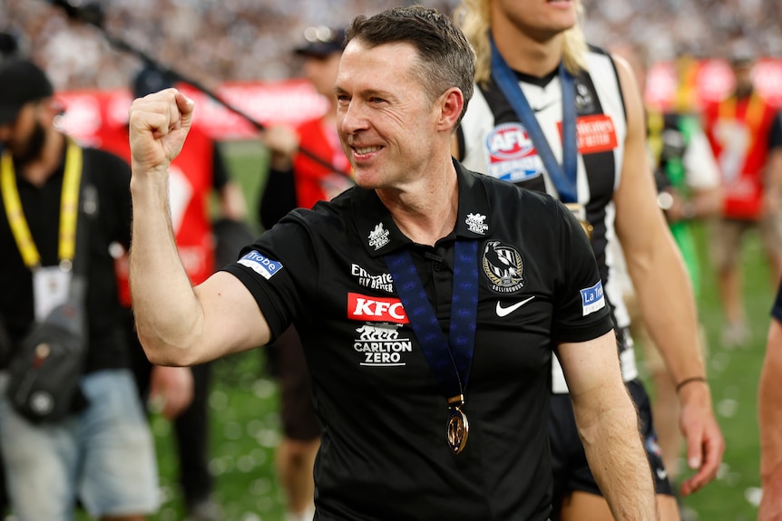 Collingwood coach Craig McRae pumps his right fist after winning the AFL grand final.