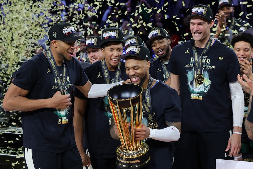 Damian Lillard holds the NBA Cup as the Bucks celebrate