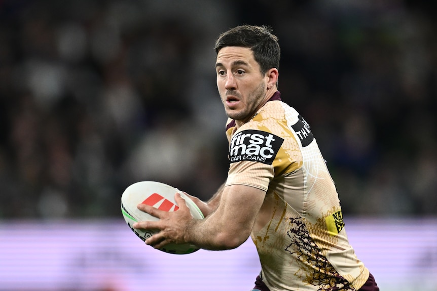 Ben Hunt playing for the Brisbane Broncos, running with the ball in both hands
