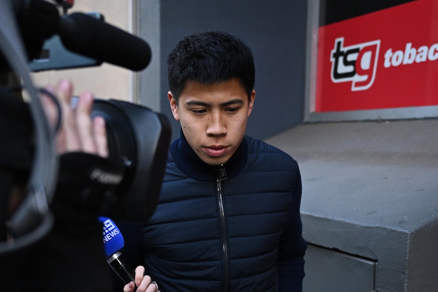 Soccer player Yuta Hirayama is filmed by media as he leaves Melbourne Magistrates' Court in July.