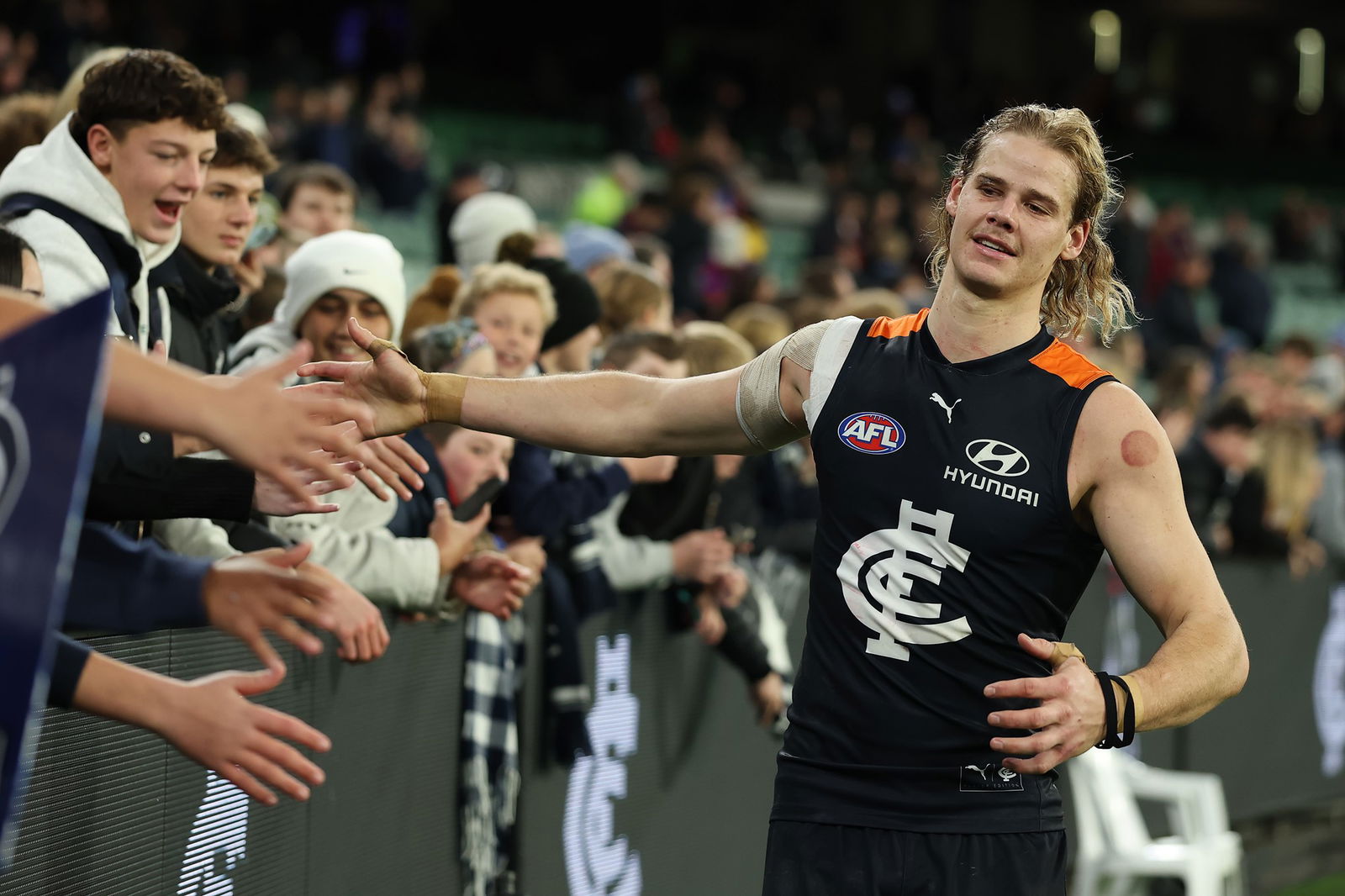 Tom De Koning of the Blues celebrates with fans after winning the round 19 AFL match between Carlton Blues and Melbourne Demons at Melbourne Cricket Ground on July 19, 2025 in Melbourne, Australia.